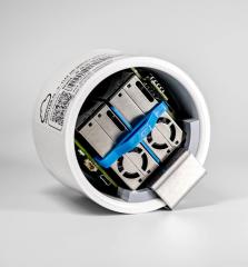 A white cylindrical container revealing electronic components inside.